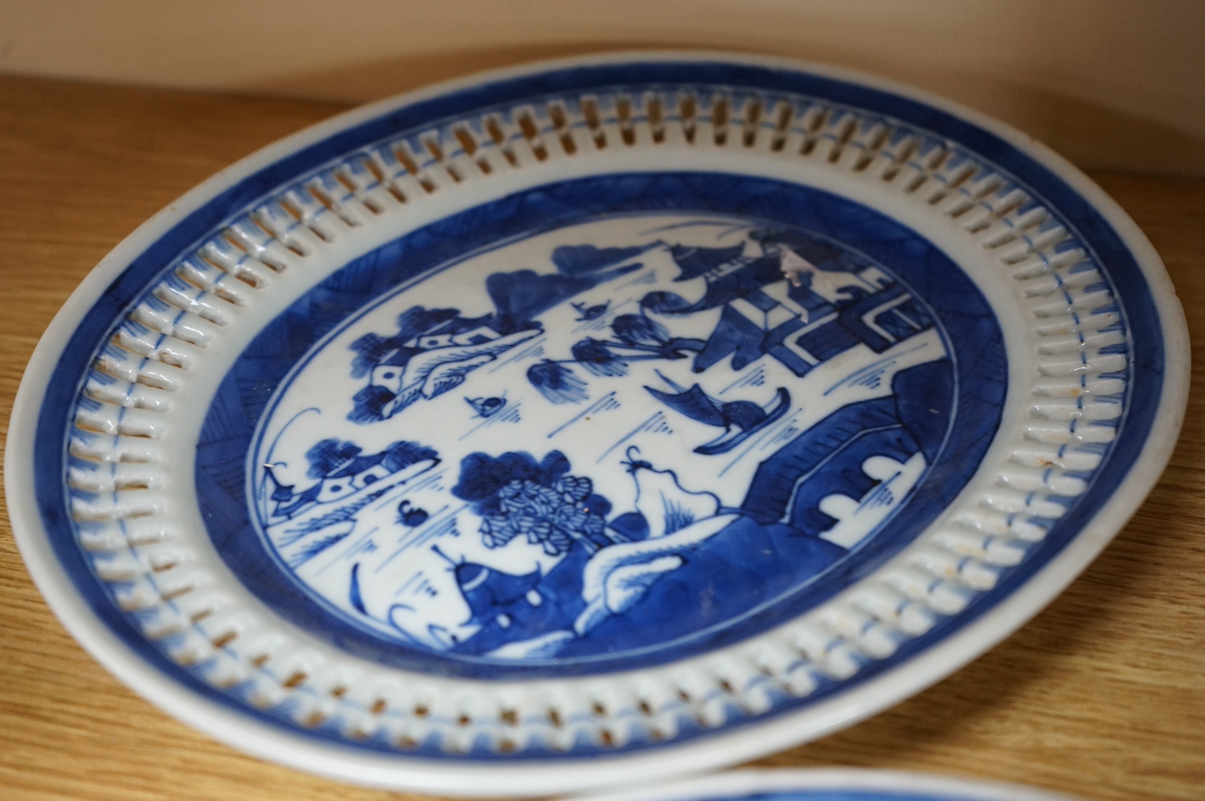 An early 19th century Chinese export blue and white chestnut dish, two related stands and a similar vase, largest 26cm high. Condition - fair